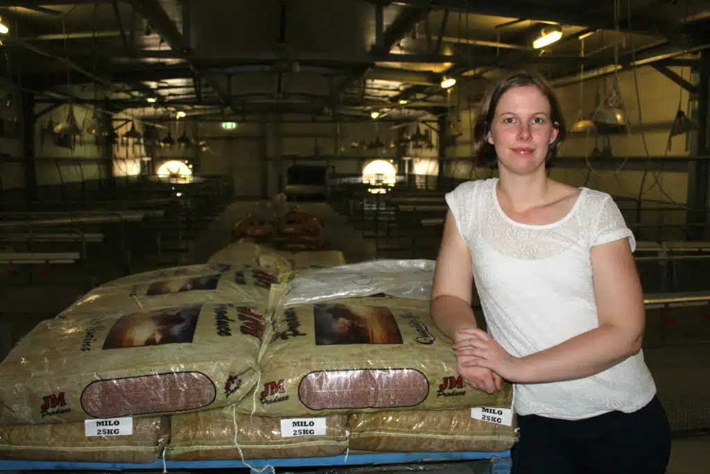 Amy with the feed they give to chickens in their studies. (Credit: Poultry Research Foundation, University of Sydney)